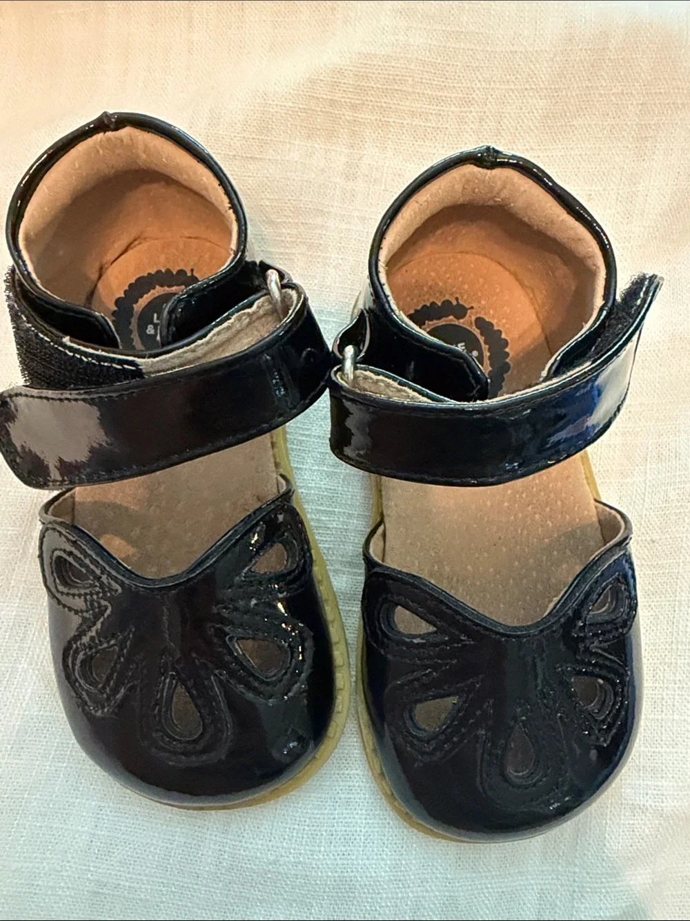 Livie & Luca Black Patent Mary Janes with Floral Cutouts